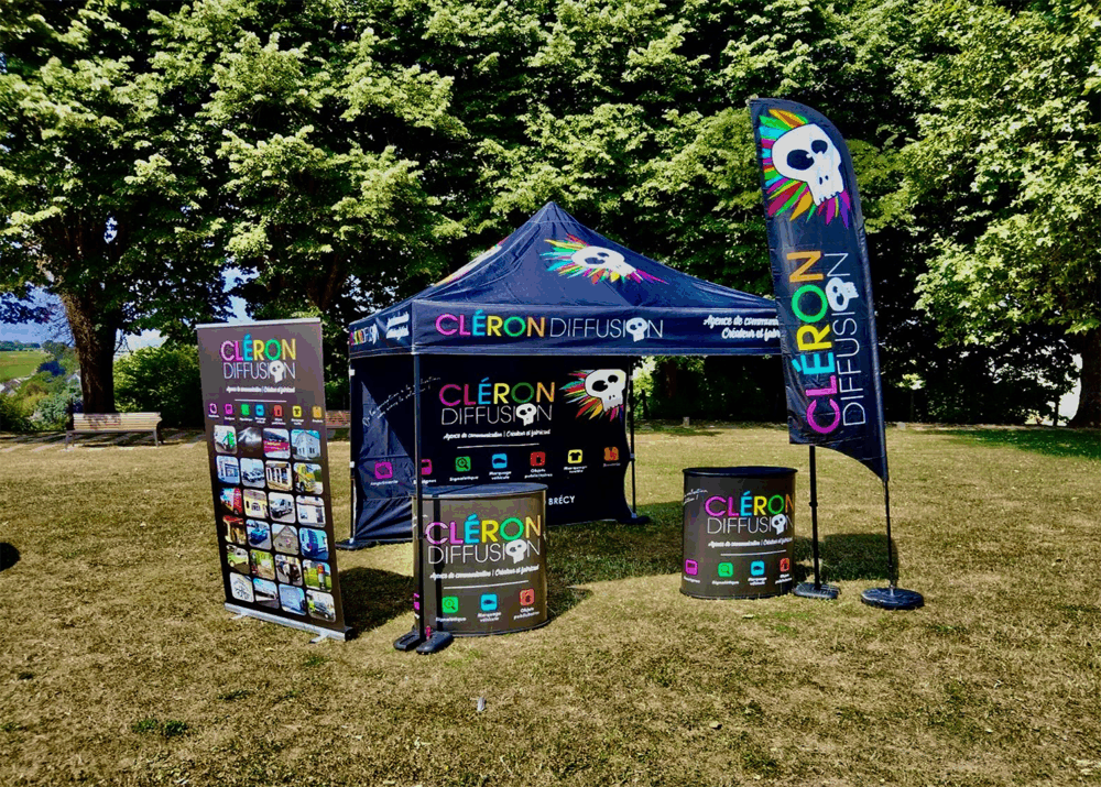Stand extérieur Cléron Diffusion avec tente, drapeaux et supports imprimés.